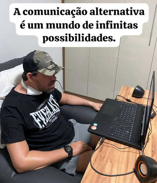 Foto de André usando seu computador com o auxilio do mouse ocular.